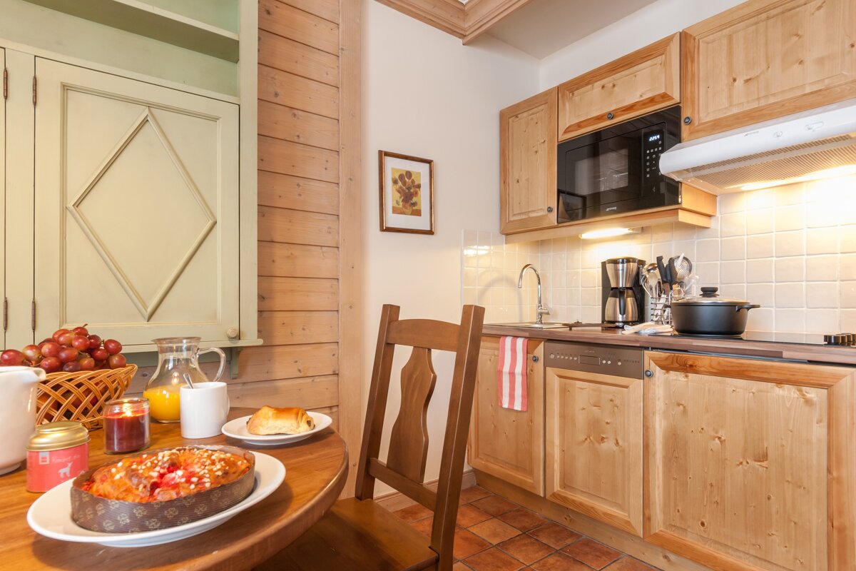 A kitchen with wooden cabinets and a microwave that says ' siemens ' on it