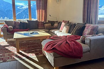 A living room with a large sectional couch and a coffee table