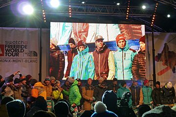 A group of people standing in front of a swatch freeride world tour banner