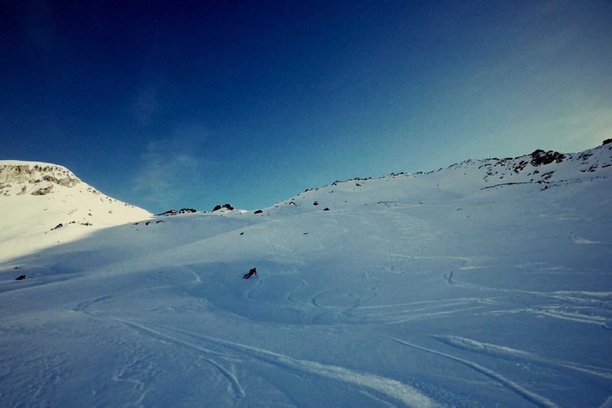 A person skiing down a snow covered mountain