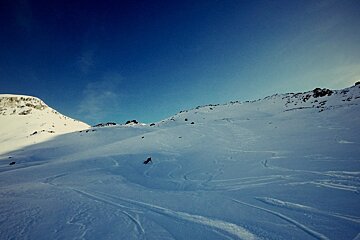 A person skiing down a snow covered mountain