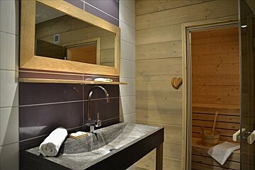 A bathroom with a sink and a heart on the wall