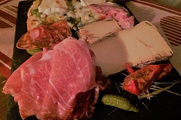 a slate of meat and cheese