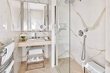 A bathroom with a sink and a walk in shower