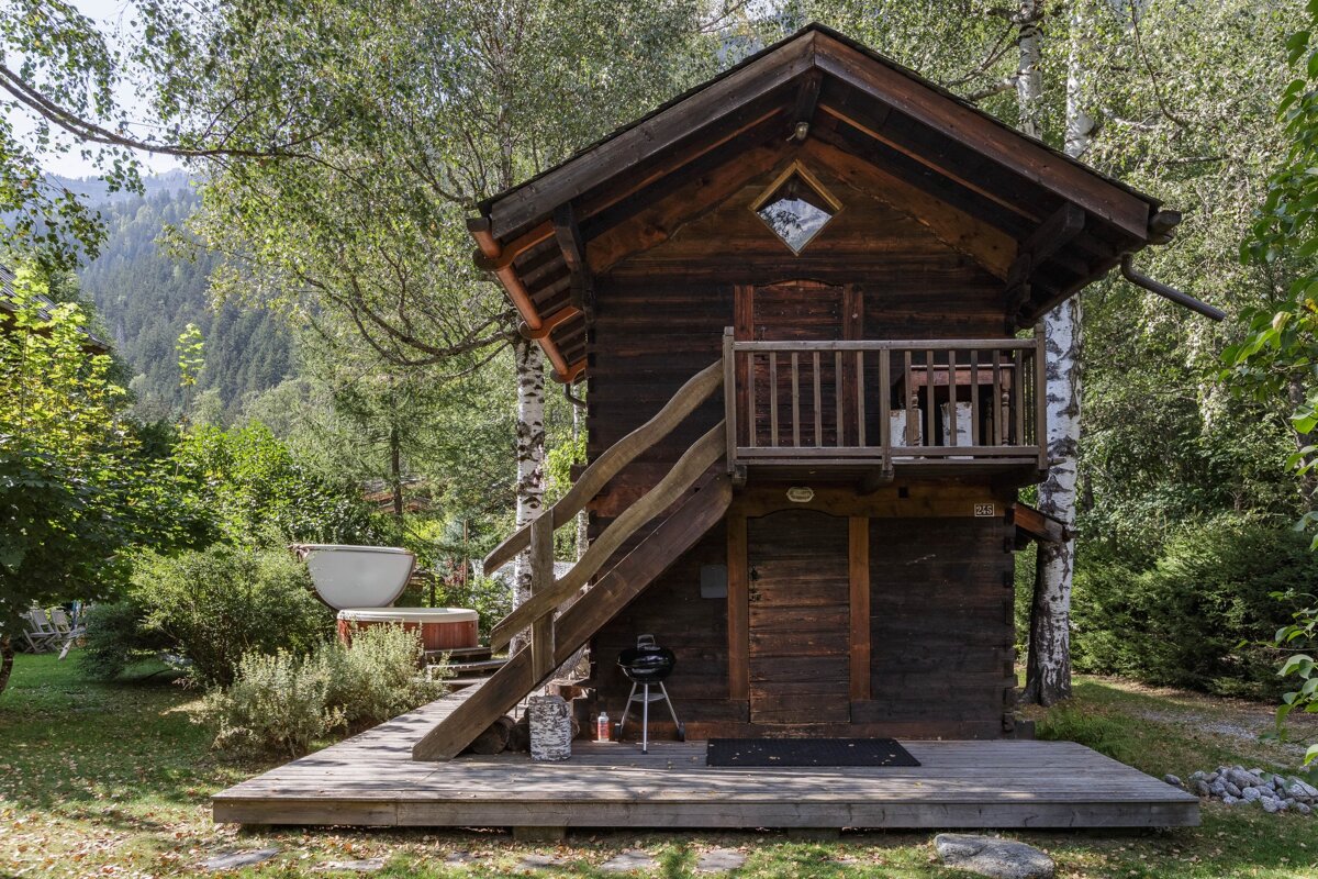 A small wooden house with stairs leading up to it