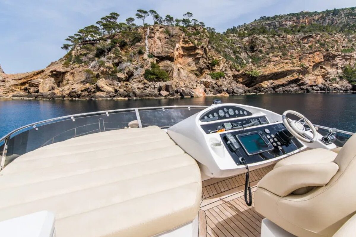 A boat with a remote control on the steering wheel