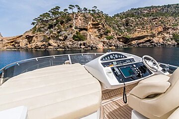 A boat with a remote control on the steering wheel