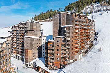 A ski resort with a lot of buildings covered in snow