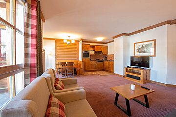 A living room with a couch a chair and a television