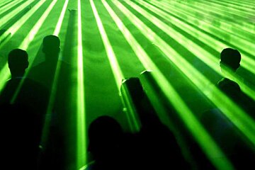 an image of a rave with green laser lights