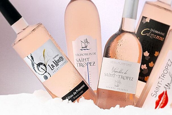 A bottle of saint tropez wine is surrounded by other bottles