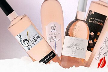 A bottle of saint tropez wine is surrounded by other bottles