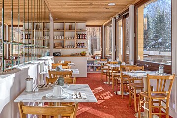 The inside of a restaurant with tables and chairs