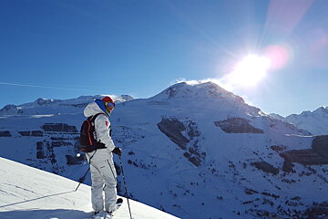 a skier in a white suit