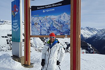 a ski instructor by a sign 