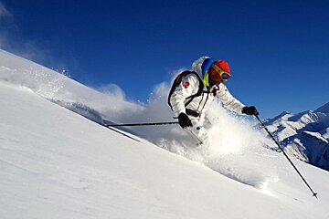 a skier in white off piste