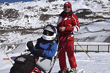 a sit skier giving a thumbs up to the camera