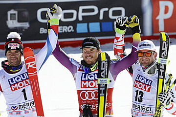 3 skiers in lycra with skis