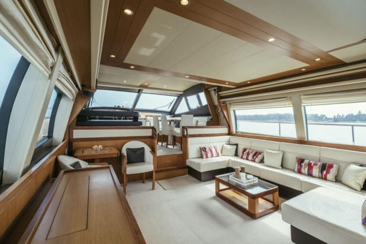 A living room on a yacht with a couch , table and chairs