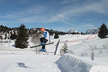 a kid skiing over a jump in les houches