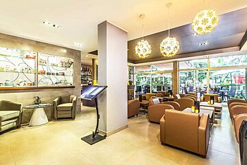 A restaurant with tables and chairs and a bar