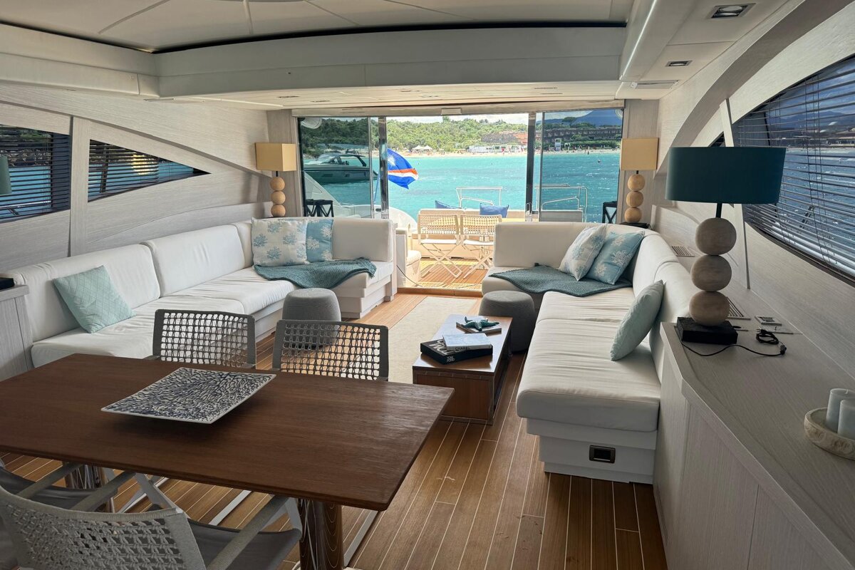 A living room on a boat with a table and chairs