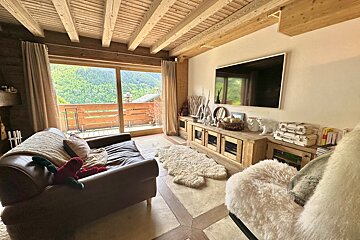 A living room with a couch and a flat screen tv
