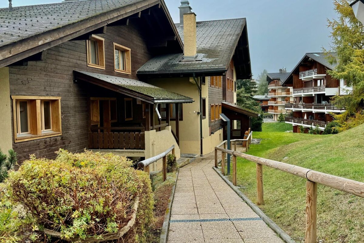 A wooden house with a walkway leading to it