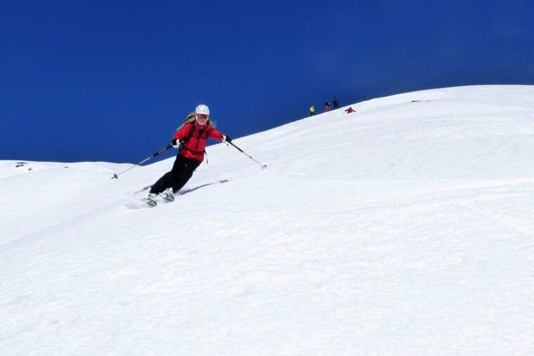a skier in a red jacket