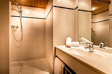 A bathroom with a sink and a walk in shower