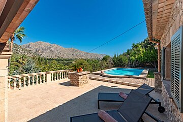A view of a swimming pool with mountains in the background