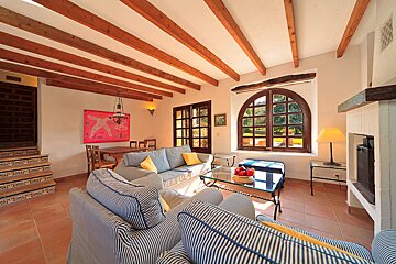 A living room with a couch a table and a fireplace