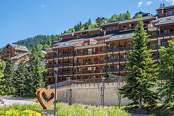 A large building with a heart shaped statue in front of it