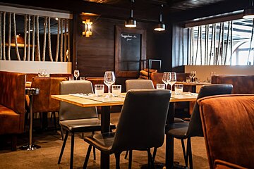 A restaurant with a chalkboard that says suggestions on it