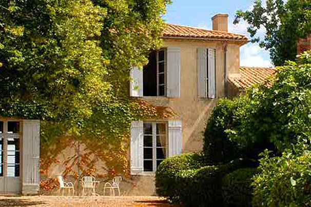 exterior of a mansion with green trees