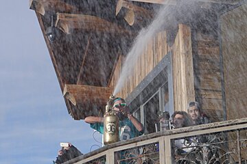 a man spraying the crowd with water