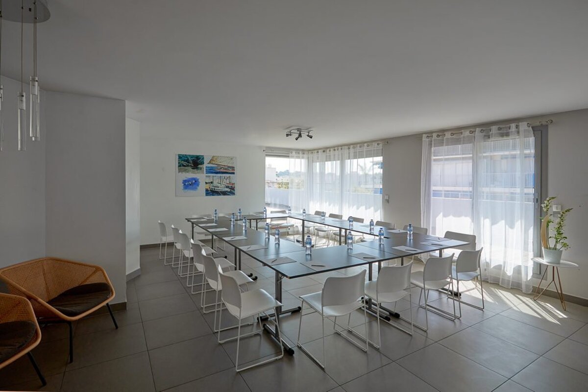 A room with tables and chairs set up for a meeting