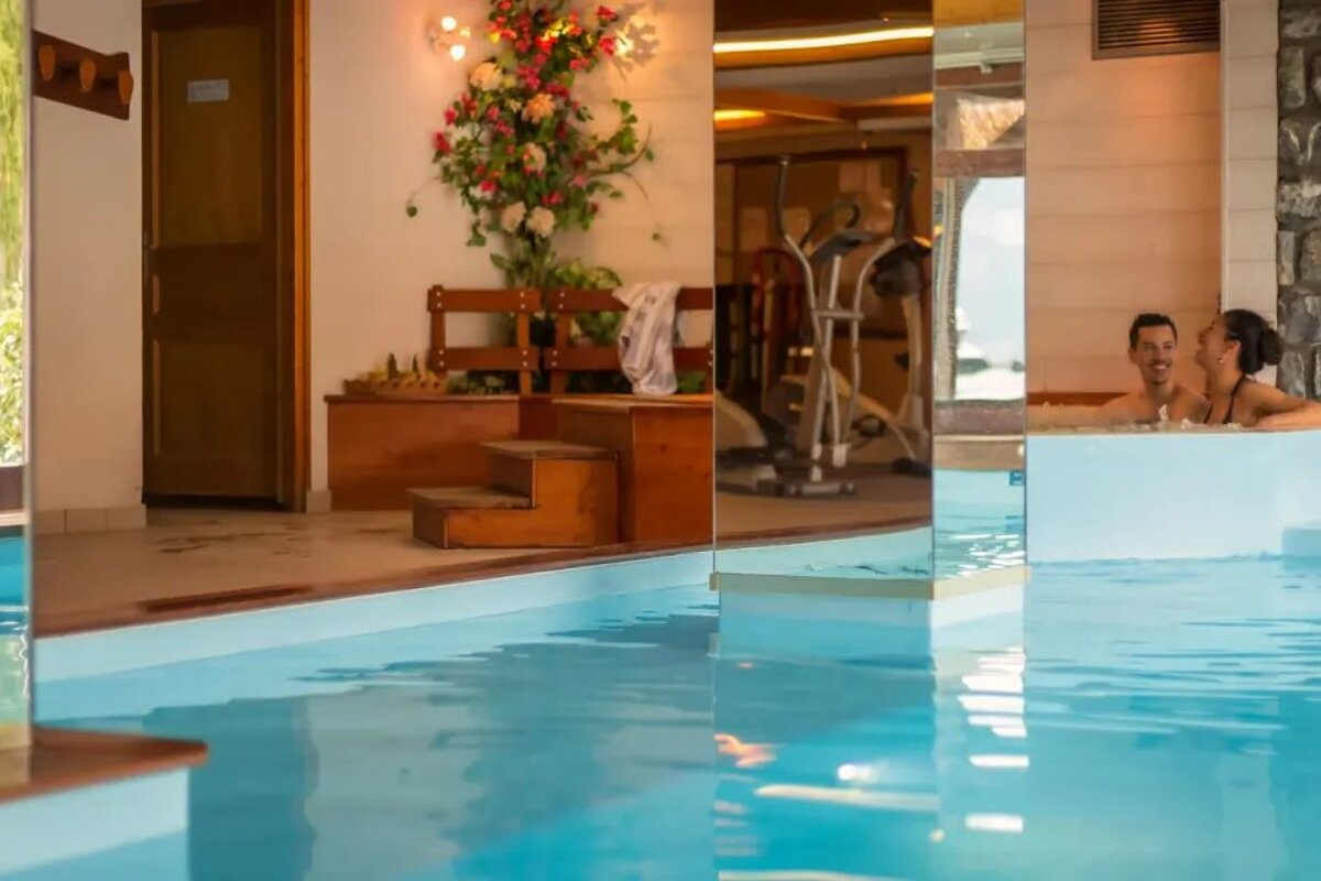 A man and a woman are sitting in a swimming pool