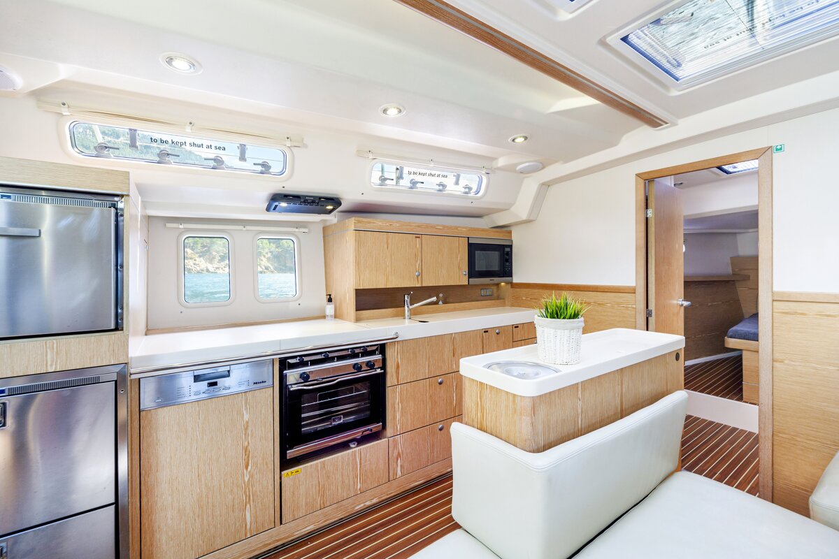 A kitchen with a stainless steel dishwasher and a stainless steel refrigerator