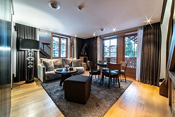 A living room with a couch a table and chairs