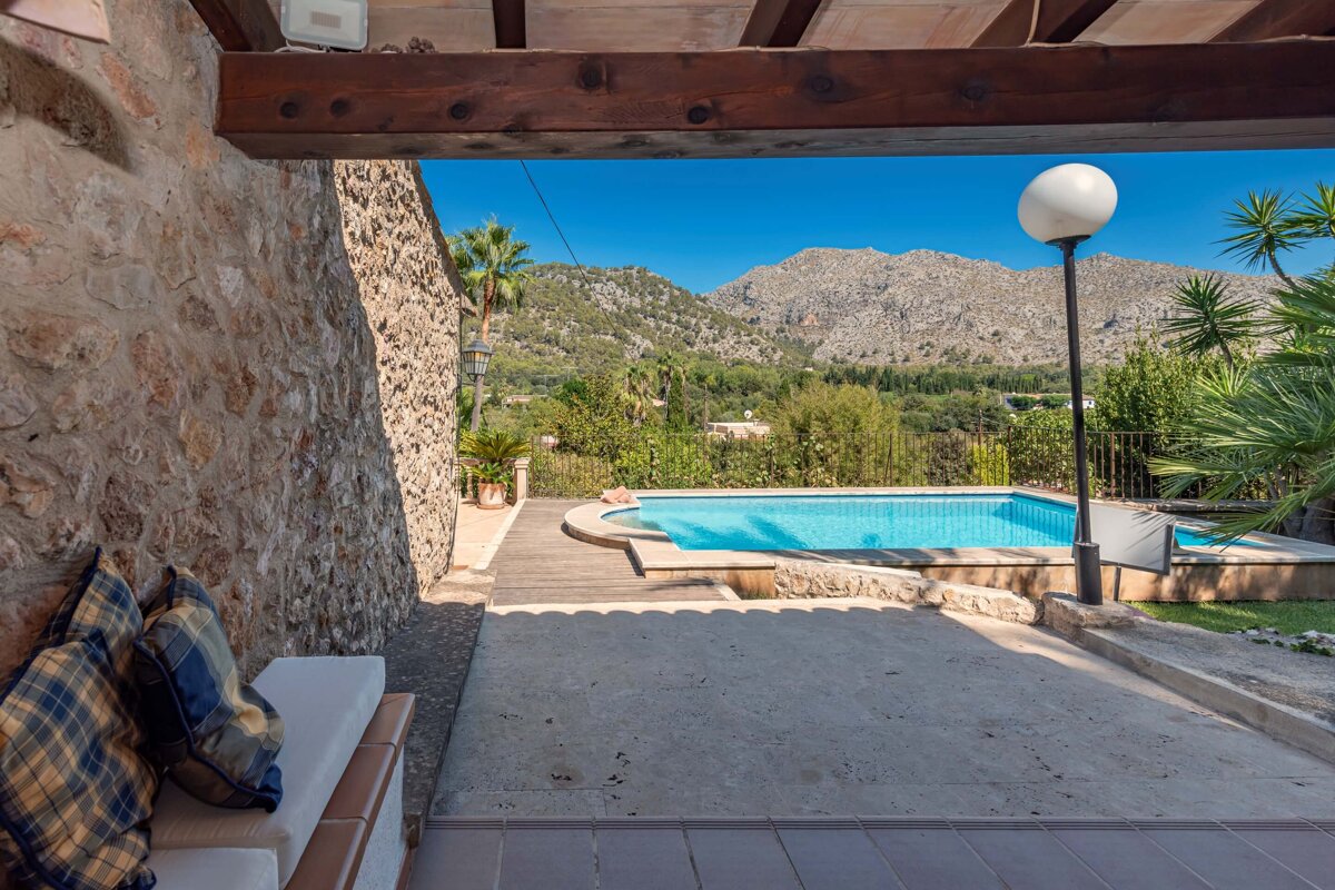 A view of a swimming pool with mountains in the background
