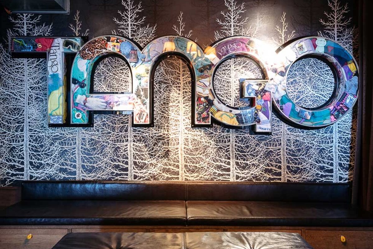 The word tango that is on a wall