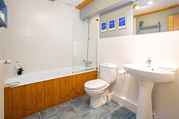 A bathroom with a sink toilet and bathtub