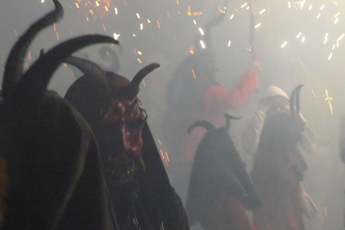demon masks being worn at a festival in mallorca
