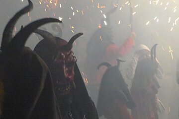 demon masks being worn at a festival in mallorca