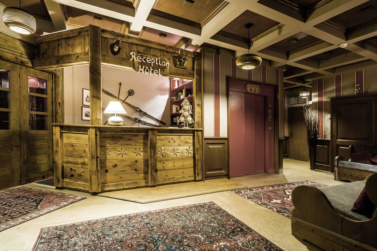 A wooden reception desk with a sign that says reception hotel