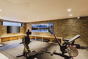 A gym with a large painting of mountains on the wall