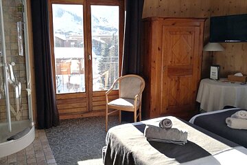 A hotel room with two beds and a chair