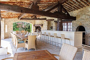 A dining area with wicker chairs and a long table
