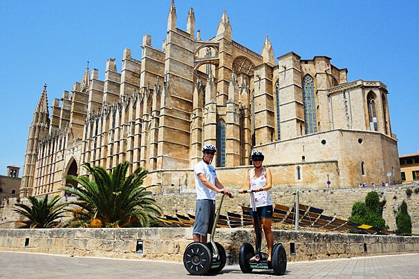 two people infront of palma cathedral on a segway